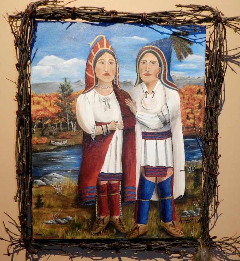 Brightly colored acrylic painting of an Abenaki man and woman standing outdoors, near a river,amd they are wearing historical Abenaki clothing. They are both wearing peaked hoods, white linen shirts are white linen ,and their bottoms are blue and red wool.