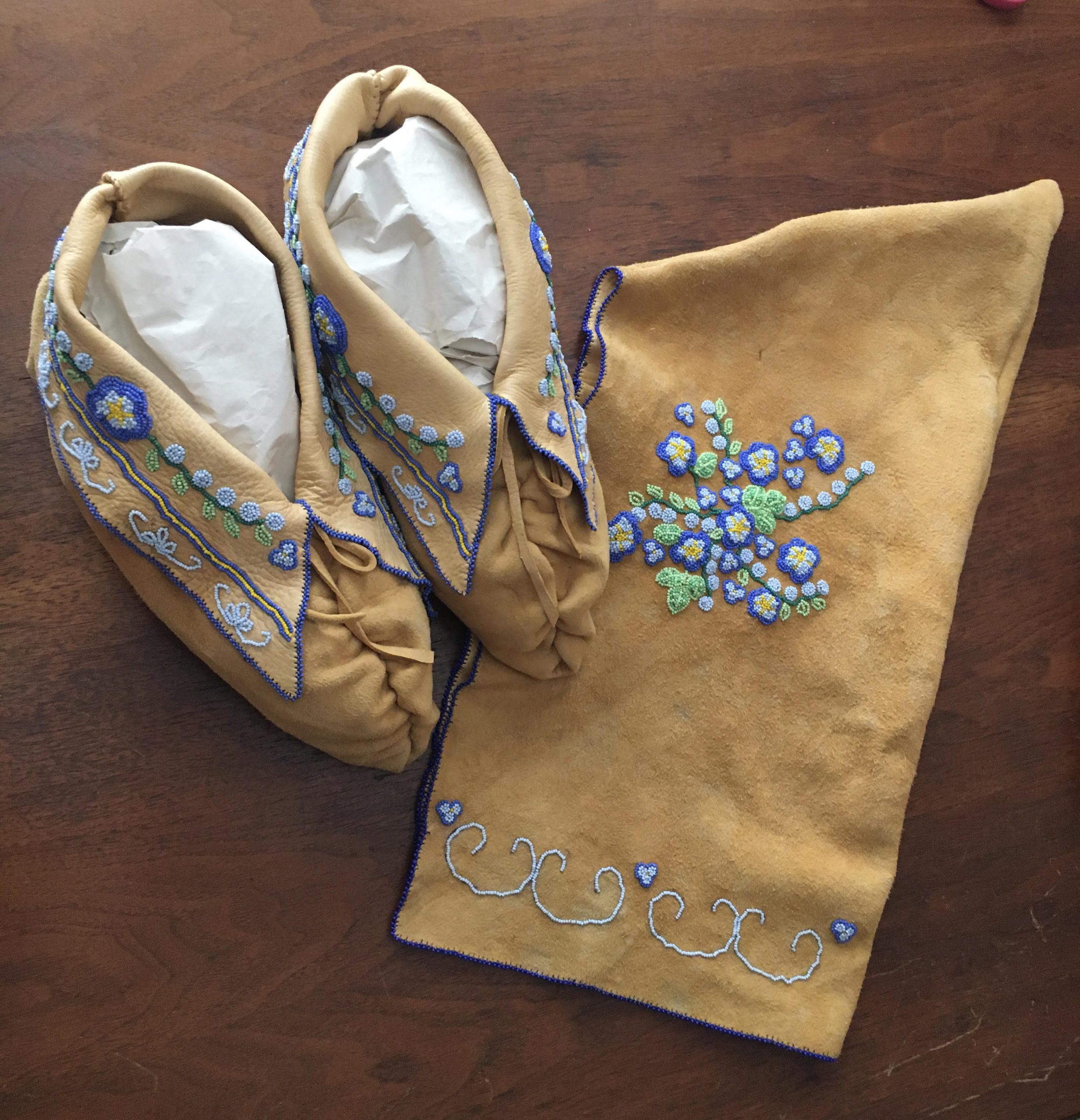 Beaded moccasins and peaked cap made by Francine Poitras Jones