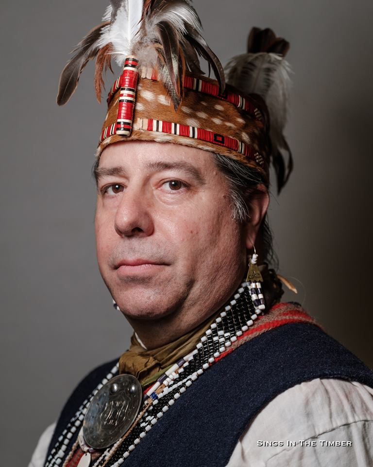 Jim Taylor wearing headpiece and jewelry.