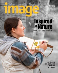 Magazine cover with Amy Hook-Therrien doing an illustration.